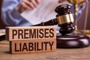 Wooden blocks spelling premises liability next to a judges gavel representing Wisconsin property owner liability law and injury claims