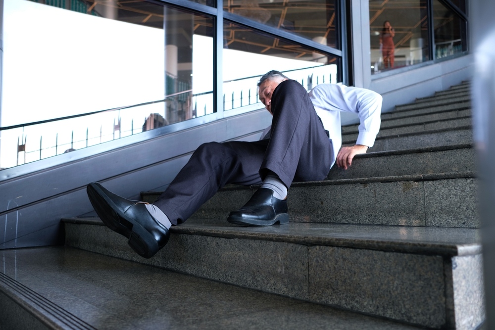 Man fallen on office stairs after a Madison slip and fall accident
