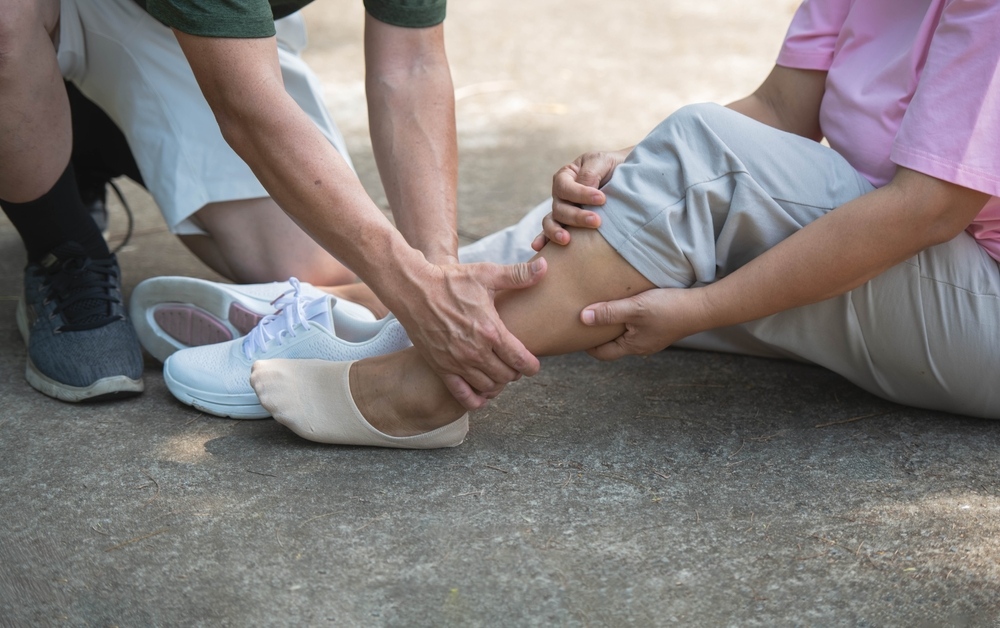 Person helping someone after a slip and fall injury in Madison, Wisconsin