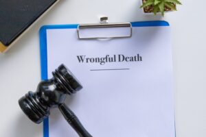 Clipboard with a Wrongful Death document next to a judge's gavel